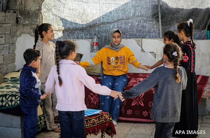 Palestinian girl Shahd Maarouf, 12, who lost one of her hands after being injured by shrapnel from Israeli shelling that struck a house next to her family's home, lives in a displacement camp in the al-Zarqa area, northe...
