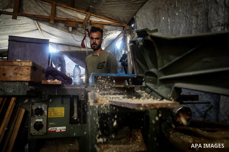 Palestinian carpenters repurpose wooden aid boxes into benches and school furniture in Gaza City, on October 27, 2026, amid shortages of wood and difficulties bringing essential materials into the Gaza Strip. The initiat...