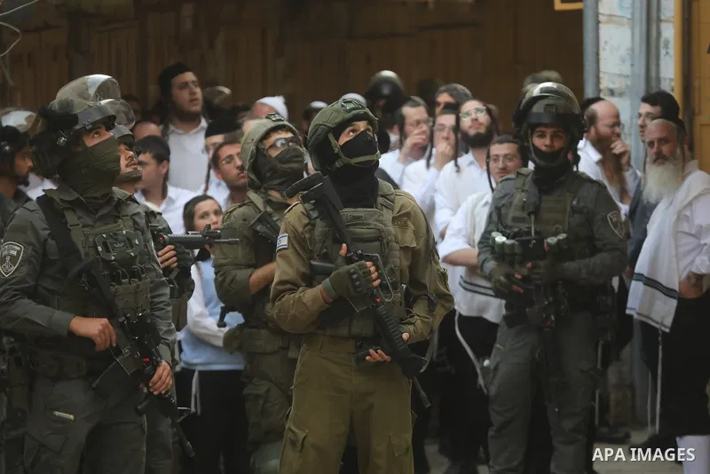 Israeli troops deploy along streets in the West Bank city of Hebron during a tour by Israeli settlers, on October 31, 2026. The deployment comes amid heightened military measures and restrictions on Palestinian movement,...