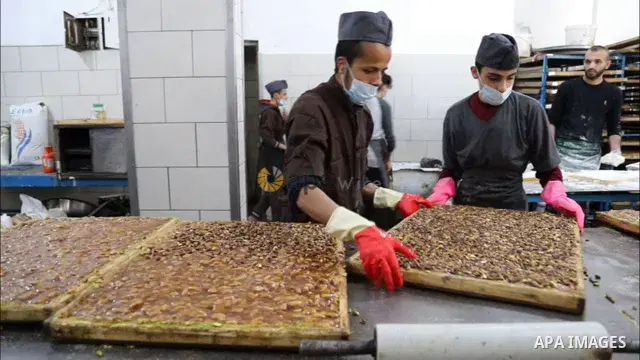 Palestinians prepare sweet known in Arabic as "Halkoum" to be sold ahead of the Eid al-Fitr holiday, at a factory in Gaza City 01.