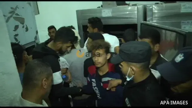 Palestinians mourn next to bodies of children killed amid a flare-up of Israeli-Palestinian violence at a hospital morgue in the northern Gaza Strip. STORYLINE 20 Palestinian were killed amid air raids in the Gaza Strip,...