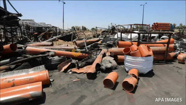 Palestinian workers inspect the damage at a factory in Gaza's industrial area which was hit by Israeli strikes prior to a cease-fire ending 11 days of deadly violence between Israel and the Palestinian Hamas movement STO...