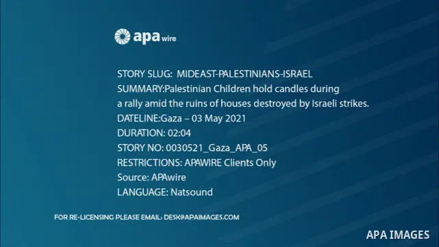 Palestinian Children hold candles during a rally amid the ruins of houses destroyed by Israeli strikes. STORYLINE The Egyptian-brokered truce ended 11 days of heavy Israeli bombing of Gaza and rocket fire from the impove...