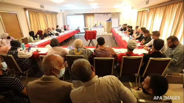 Palestinians attend a meeting about election awareness in Gaza City.