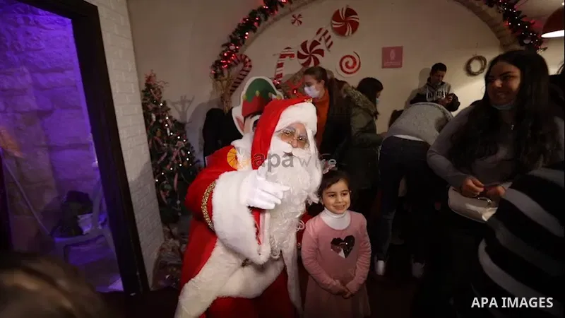 A Palestinian Christian man dressed as Santa Claus dances with children during Christmas celebrations, in the West Bank city of Bethlehem. 0.1