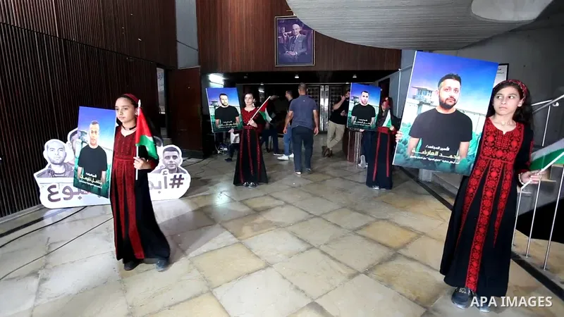 Palestinians take part in an event marking the first anniversary of six Palestinian prisoners escaped from Israeli Gilboa Prison, in Gaza city. 0.1