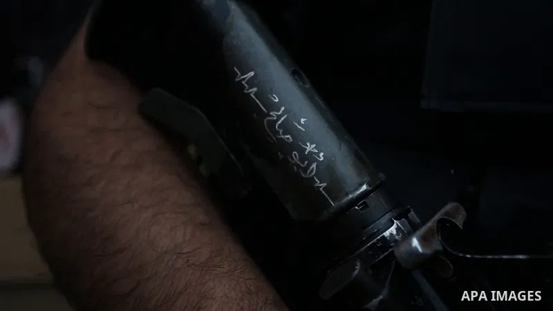 Palestinian militants hold their weapons during a memorial service of Mohammed al-Azizi and Abdul Rahman Sobh who were killed by Israeli forces on 24 July, in the West Bank city of Nablus. Footage by /APA