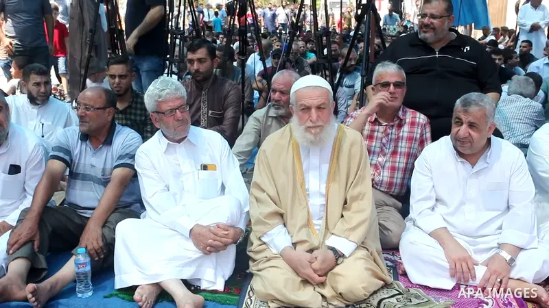 Palestinians attend Friday prayer in solidarity with pisoners in Israeli jails, in front of Red Cross office in Gaza city. 0.1