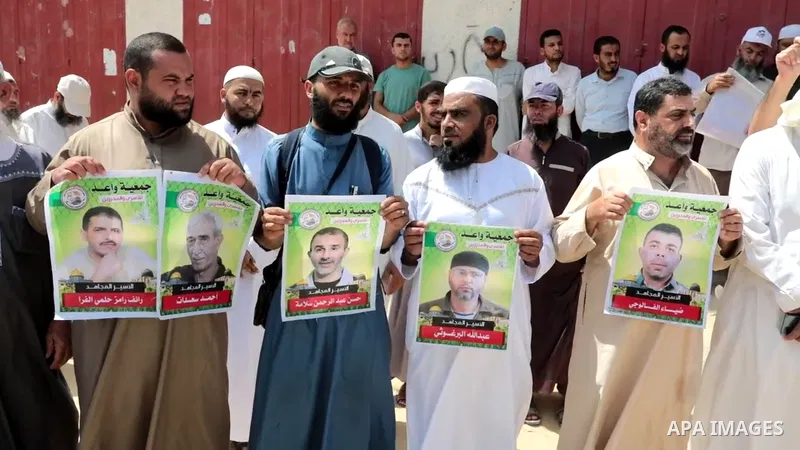 Palestinians take part in a protest in solidarity with prisoners on hunger strike in Israeli jails, in front of the headquarters of the Red Cross in Khan Yunis in the southern Gaza Strip 0.1