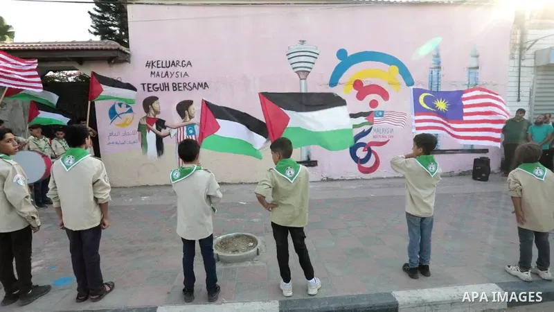 Palestinians attend the opening of a mural on the occasion of Malaysian National Day, in Gaza City.