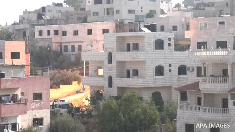 Smoke billows from a building during clashes between Israeli forces and Palestinians in the town of Rujayb, east of the West Bank city of Nablus.