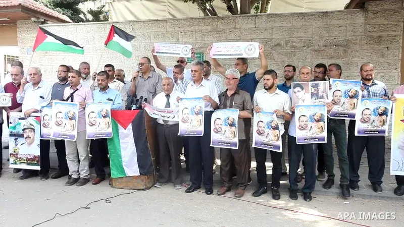 Palestinians take part in a protest in solidarity with prisoners on hunger strike in Israeli jails, in front of Red Cross office, in Gaza city 01.