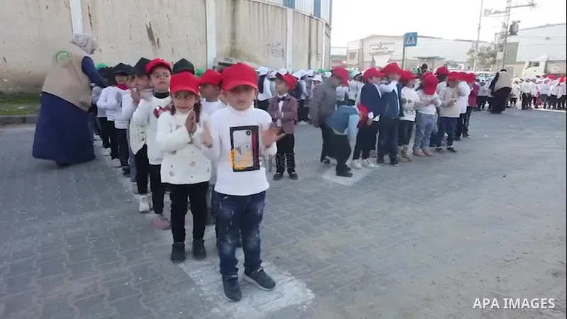 Palestinian children hold Kuwait national flags during a celebration to mark the Kuwaiti National and Liberation Days, in Gaza city. 0.1