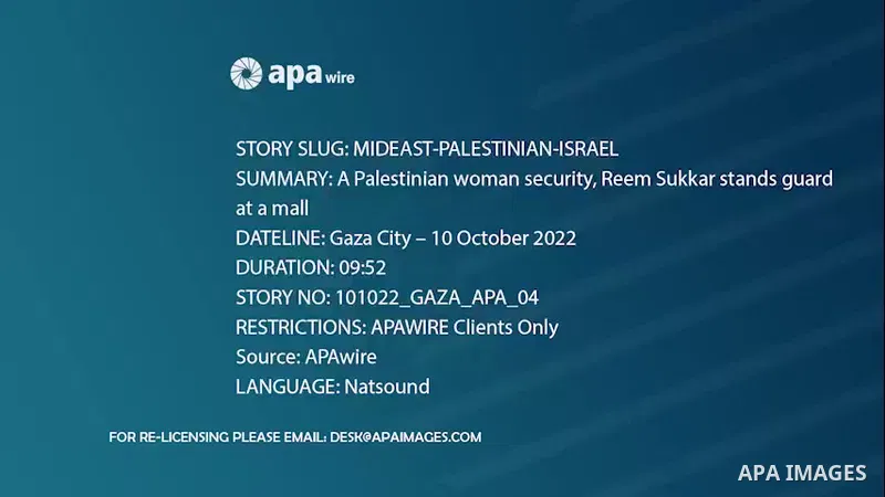 A Palestinian woman security, Reem Sukkar stands guard at a mall in Gaza City. 0.1