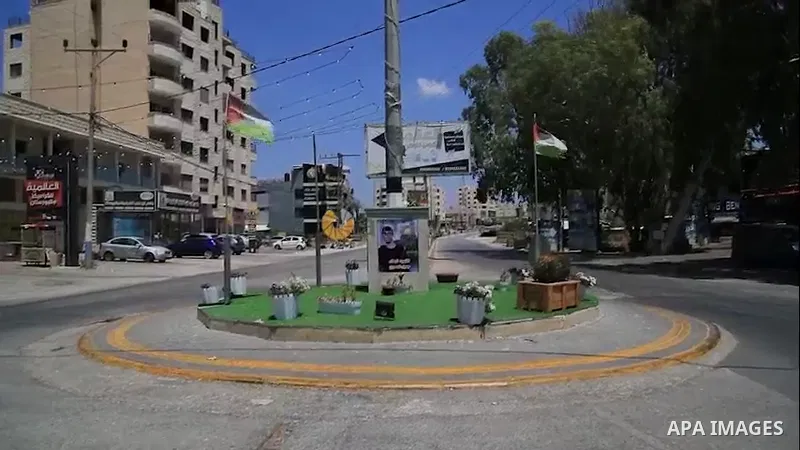 Palestinians walk past memorials bearing the names of Palestinians killed by the Israeli army on the past months, in the West Bank city of Jenin. 0.1