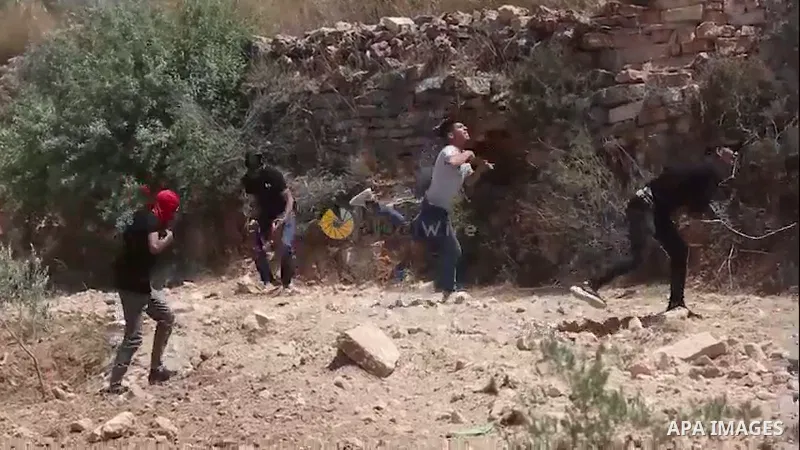 Palestinian protesters clash with Israeli forces during a demonstration against settlements in the village of Beita in the West Bank.