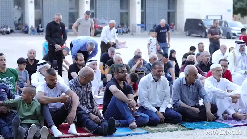 Palestinians pray on the first day of Muslim holiday of Eid al-Adha at the Manger Square of the Church of the Nativity in the West Bank city of Bethlehem. 0.1