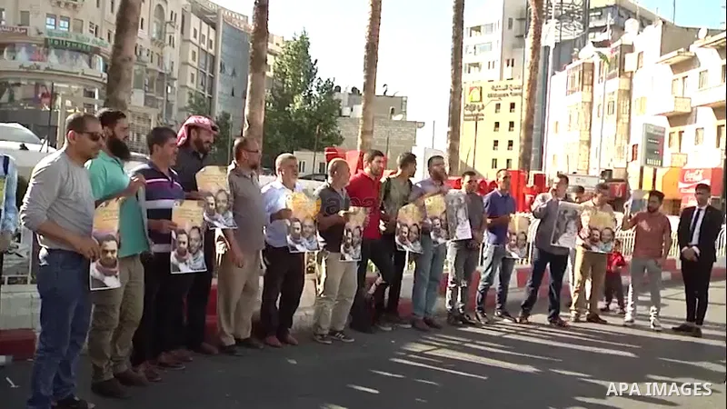 Palestinians take part in a protest in solidarity with prisoners on hunger strike at Israeli jails, in the West Bank city of Ramallah. 0.1