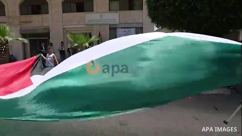 Palestinians wave national flags as they take part in a rally in Gaza city. 0.1