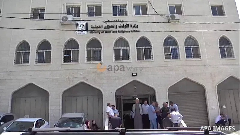 Palestinians attend the announcement of names of persons eligible to travel to Mecca to perform Hajj, at the Ministry of Awqaf and Religious Affairs in the West Bank city of Al-Bireh. 0.1