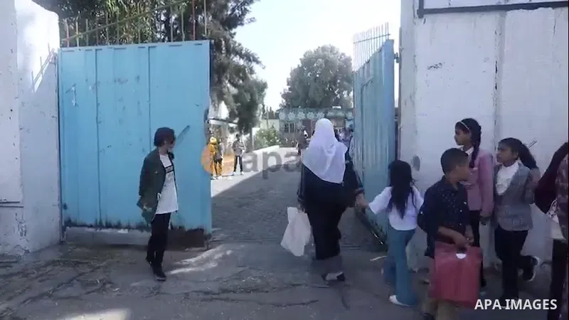 Palestinian students receive their the school certificates, in Gaza city Footage by APA