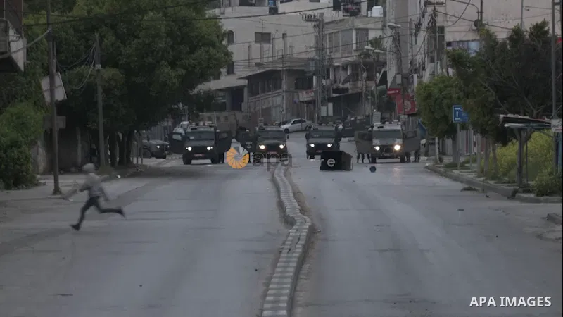 Palestinian protesters clash with Israeli forces, in the West Bank city of Nablus