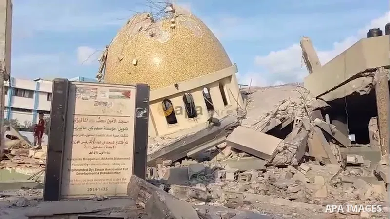 Palestinians inspect the ruins of a building destroyed in Israeli airstrikes in Khan Younis in the southern of Gaza strip