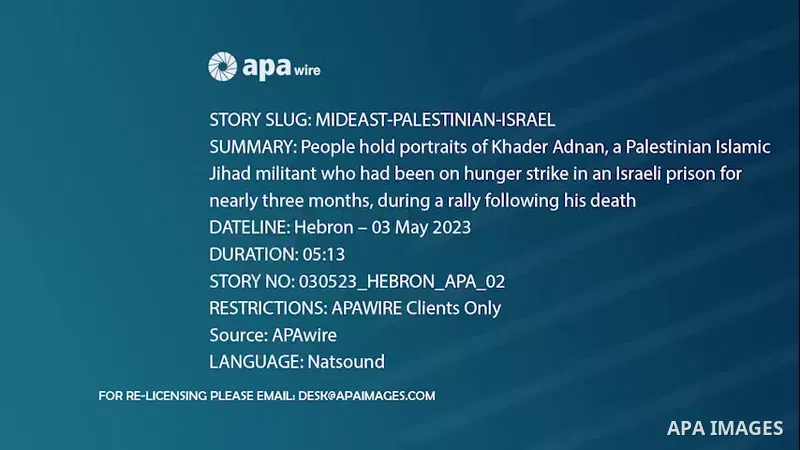 People hold portraits of Khader Adnan, a Palestinian Islamic Jihad militant who had been on hunger strike in an Israeli prison for nearly three months, during a rally following his death, in the West Bank city of Hebron....