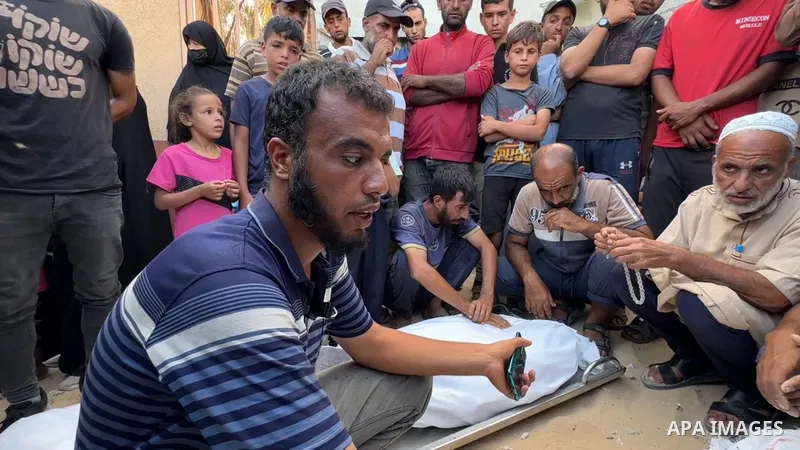 Restrictions Summary: APA wire clients only Shortlist: APAwire - APA wire clients only, Khan Yunis- August 26, 2025. Palestinians mourn by the shrouded bodies of loved ones killed in Israeli strikes on Khan Yunis, ahead...