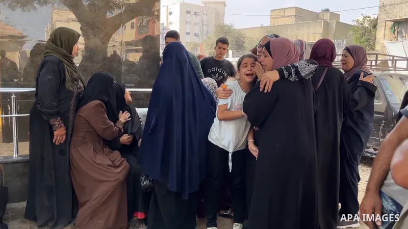 Restrictions Summary: APA wire clients only Shortlist: APAwire - APA wire clients only, Gaza- July 10, 2025. Relatives of Palestinians killed in an Israeli airstrike mourn at the morgue of Al-Shifa Hospital in Gaza City,...