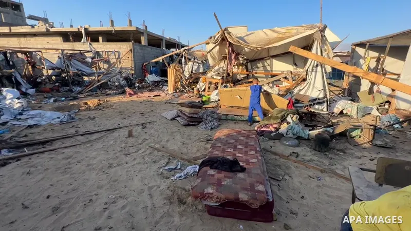 Restrictions Summary: APA wire clients only Shortlist: APAwire - APA wire clients only, Khan Yunis- July 9, 2025. Palestinians inspect the damage at the site of an overnight Israeli air strike on a tent sheltering displa...