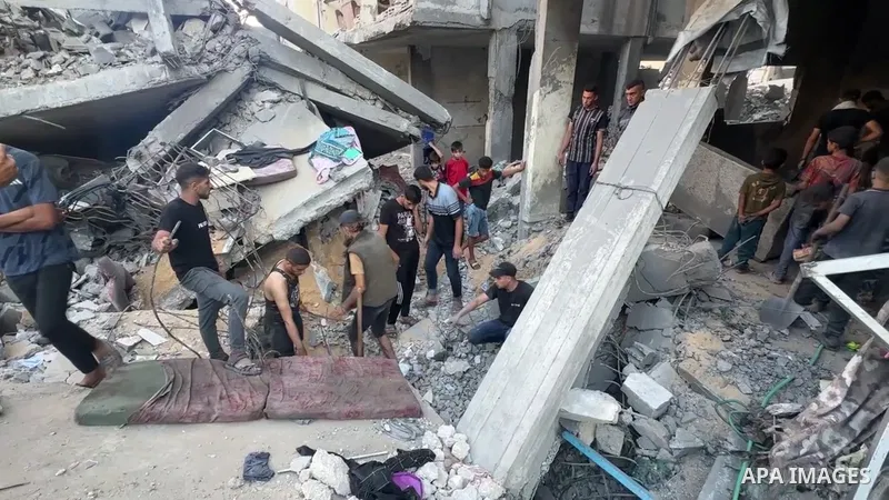 Restrictions Summary: APA wire clients only Shortlist: APAwire - APA wire clients only, Gaza- July 9, 2025. Palestinians inspect the rubble of the Jouda family's home, destroyed by Israeli airstrikes in Al-Shati refugee...