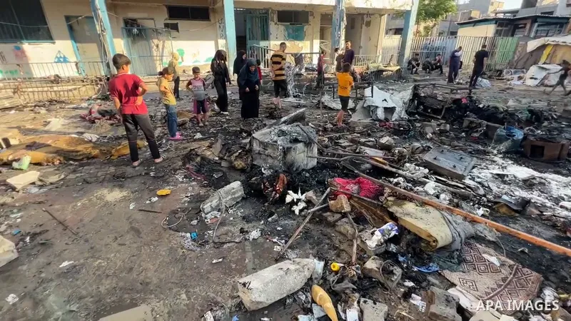 Restrictions Summary: APA wire clients only Shortlist: APAwire - APA wire clients only, Bureij- July 8, 2025. Palestinians inspect the damage following a fire that broke out after an Israeli attack with UAVs hit Abu Hilo...
