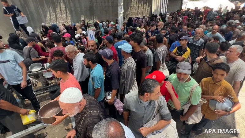 Restrictions Summary: APA wire clients only Shortlist: APAwire - APA wire clients only, Nusaierat- July 6, 2025. Internally displaced Palestinians gather in a charity kitchen to receive limited rations amid a shortage of...