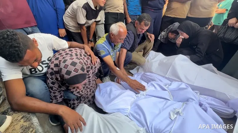 Restrictions Summary: APA wire clients only Shortlist: APAwire - APA wire clients only, Gaza- July 3, 2025. Relatives of Palestinians who lost their lives mourn in Al-Shifa Hospital after an Israeli bombing at Mustafa Ha...