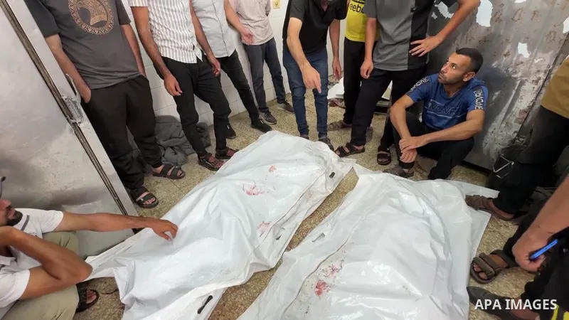 Restrictions Summary: APA wire clients only Shortlist: APAwire - APA wire clients only, Deir El-Balah-July 1, 2025. Mourners pray next to the bodies of Palestinians killed in an Israeli strike on a house on Monday, accor...