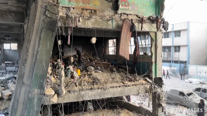 Restrictions Summary: APA wire clients only Shortlist: APAwire - APA wire clients only, Gaza city- June 30, 2025. Palestinian inspect the destruction of the buildings after the Israeli attacks on Al-Falah School, located...