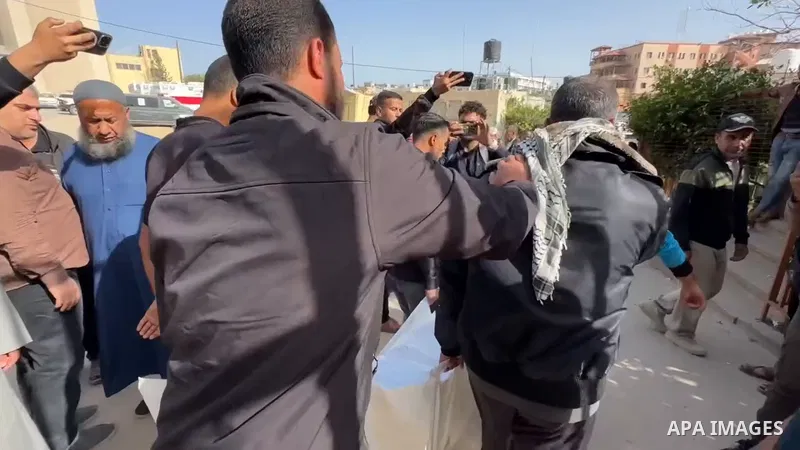 The bodies of the Palestinians, who lost their lives in the Israeli strike in the central Gaza Strip, are seen at the of the Nasser Hospital in Khan Yunis, Gaza Strip, where grieving relatives of the deceased are mournin...