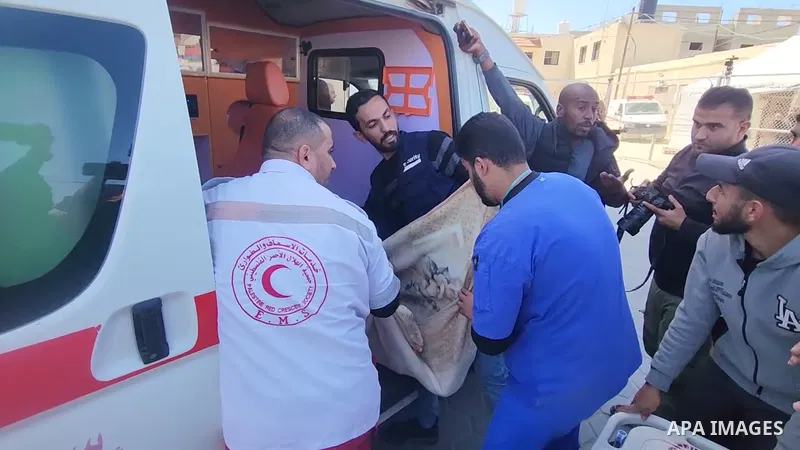 Medics and staff transport the body of a foreign UN worker out of an ambulance at Al-Aqsa Martyrs Hospital in Deir el-Balah, in the central Gaza Strip on March 19, 2025. The health ministry in Gaza said that a foreign UN...