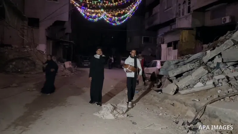 A Palestinian "Musaharati" plays the traditional role of the "Ramadan drummer" who wakes up Muslims for the traditional "Suhoor" meal during the holy month of Ramadan, as he walks through the town of Khan Yunis in the so...
