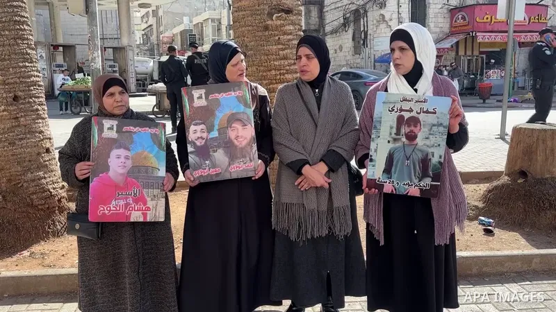 Palestinian demonstrators take part in a protest against cutting salaries of prisoners, martyrs and wounded and diverting them to aid in the West Bank city of Nablus.
