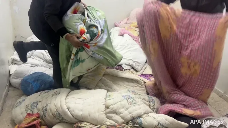 Palestinians distribute food and clothing to internally displaced people from the Far'a refugee camp in the northern West Bank, after they left their homes during the Israeli military operation on the camp.