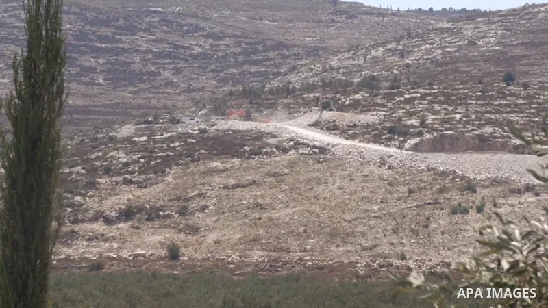 APAwire - APAwire CLIENTS ONLY, Qabatiya, West Bank, Date not provided. Israeli army bulldozers continue clearing Palestinian land between Qabatiya and Marka, south of Jenin, for the planned establishment of a military p...