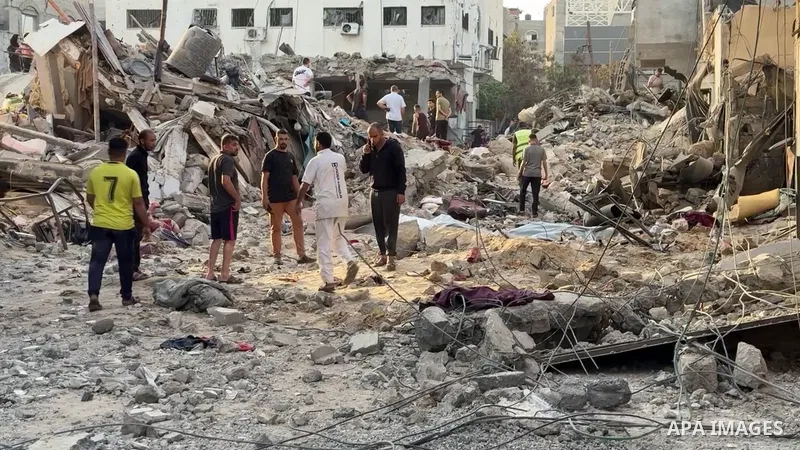 Palestinians inspect destroyed buildings at the site of an Israeli airstrike.