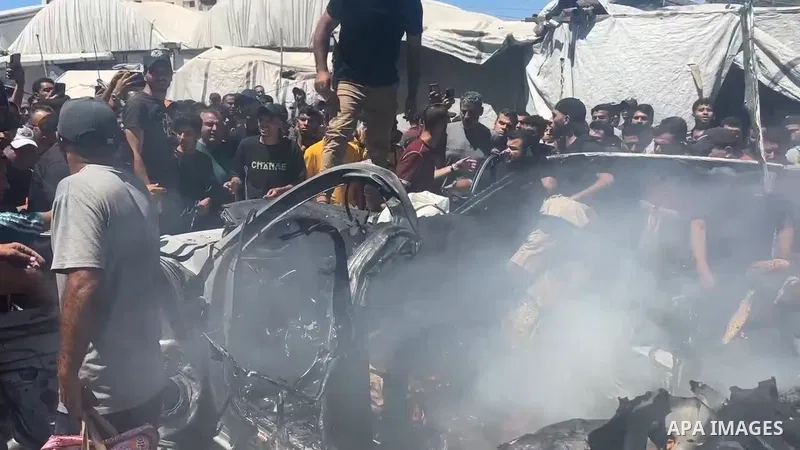 Restrictions Summary: APA wire clients only Shortlist: APAwire - APA wire clients only, Gaza- June 18, 2026. Palestinians and Civil Defense personnel gather around a destroyed vehicle that was targeted in an Israeli airs...