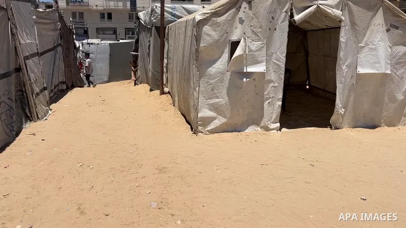 Restrictions Summary: APA wire clients only Shortlist: APAwire - APA wire clients only, Gaza- June 18, 2026. Palestinian students Yazan Ziyara and Ali al-Samlousi review their lessons inside a displacement tent in Gaza C...