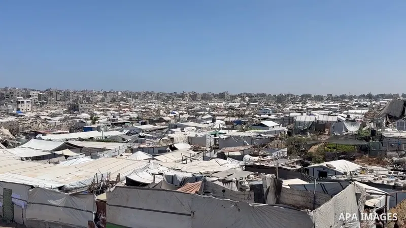 Restrictions Summary: APA wire clients only Shortlist: APAwire - APA wire clients only, Gaza City- June 17, 2026. Displaced Palestinian children carry empty containers as they head to a charity kitchen distributing free...