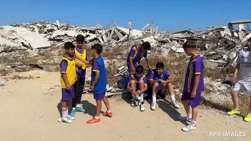 Restrictions Summary: APA wire clients only Shortlist: APAwire - APA wire clients only, Gaza City- June 16, 2026. Displaced Palestinian children wearing sports uniforms take part in a football training session with their...