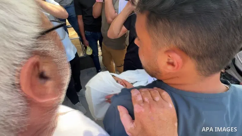 Restrictions Summary: APA wire clients only Shortlist: APAwire - APA wire clients only, Gaza- June 15, 2026. Palestinians bid farewell to the bodies of nurse Mohammed al-Hbeil and his child at al-Shifa Hospital in Gaza C...