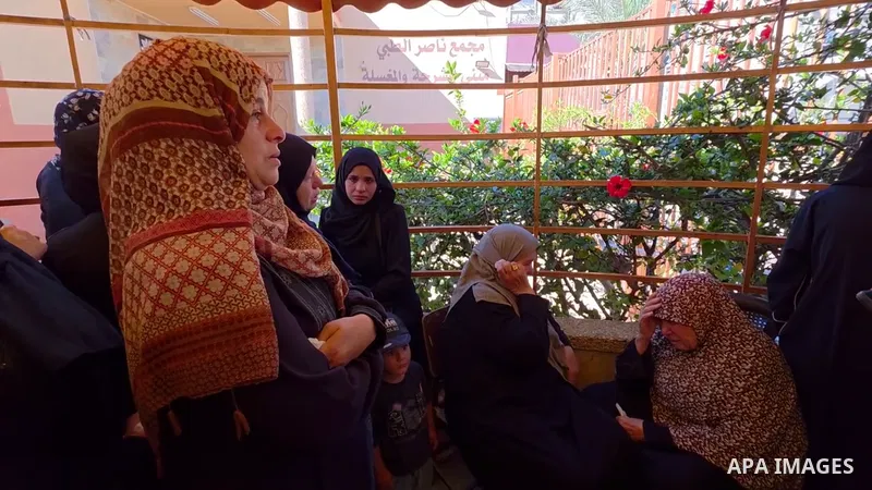 Restrictions Summary: APA wire clients only Shortlist: APAwire - APA wire clients only, Khan Younis- June 14, 2026. Relatives and mourners bid farewell to the bodies of child Amir al-Basheeti and young man Zaki al-Qarra...